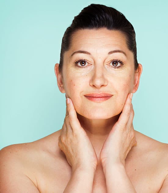 Beautiful Woman Touching her Lower Face with Both Hands | Montecito Med Spa in Montecito, CA