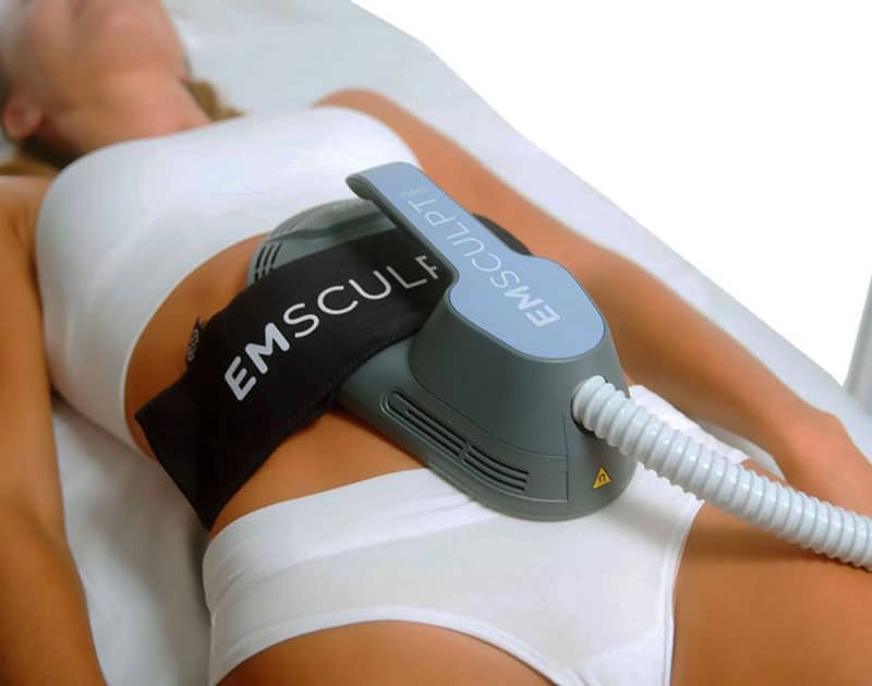 Lying Woman Receiving Emsculpt NEO Treatment in Stomach | Montecito Med Spa in Montecito, CA