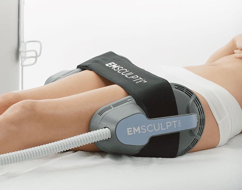 Lying Woman Receiving Emsculpt NEO Treatment on her Thighs | Montecito Med Spa in Montecito, CA