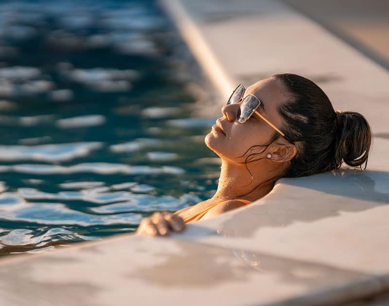 Young Woman relaxing at swimming pool | Montecito Med Spa | Montecito, CA