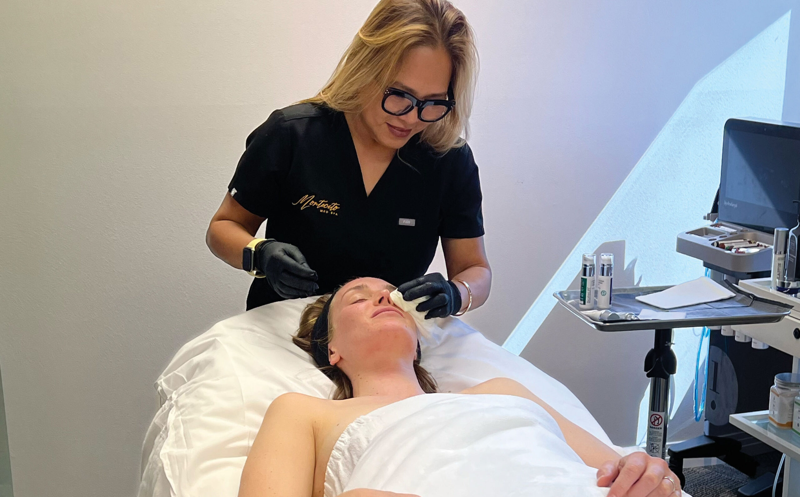 Montecito Med Spa owner, Karen Neary, performing face treatment on client